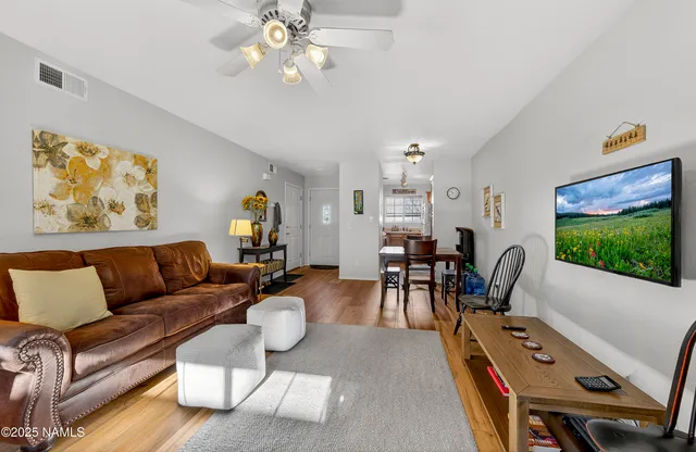 a living room with furniture and a flat screen tv