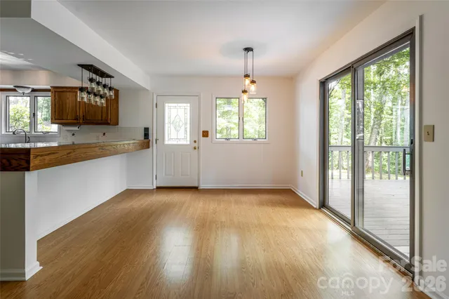 a view of a kitchen with a sink and wooden floor