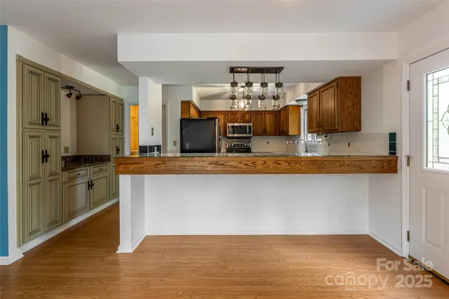 a view of kitchen with cabinets and wooden floor