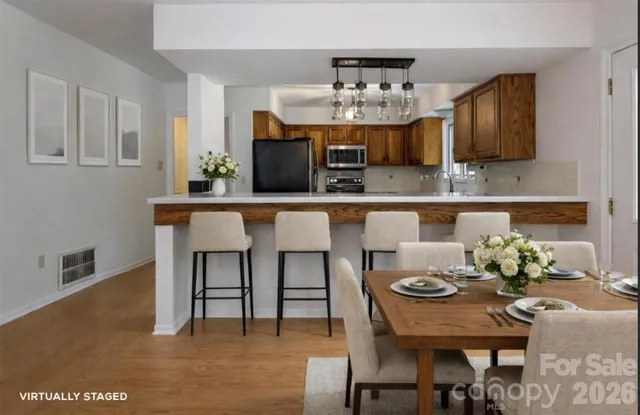 a view of a dining room with furniture and wooden floor