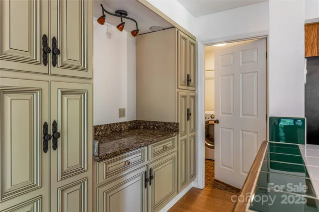 a bathroom with a granite countertop sink and shower