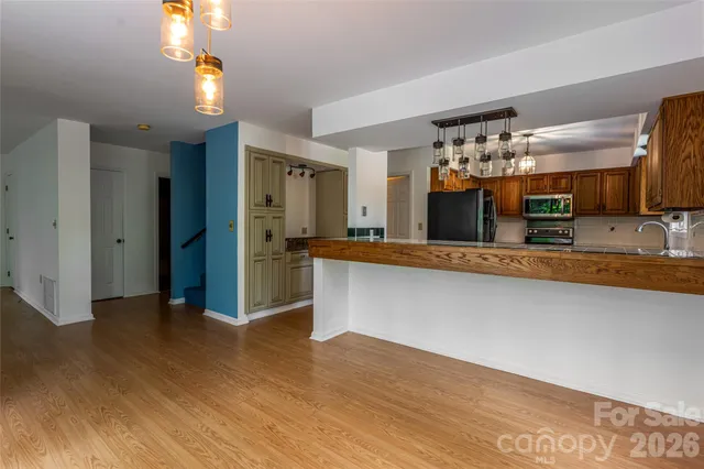 a view of a kitchen with a sink and a refrigerator