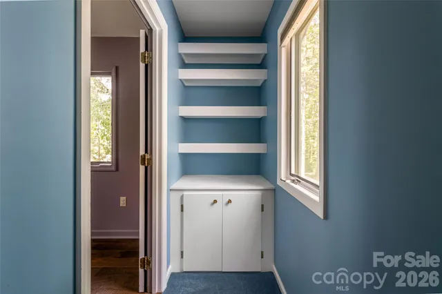 a view of walk in closet with empty racks
