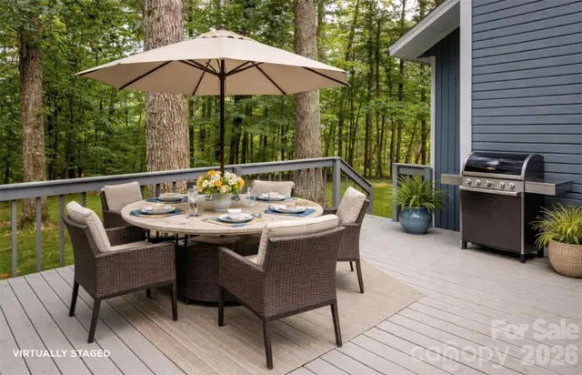 a patio with a table and chairs under an umbrella