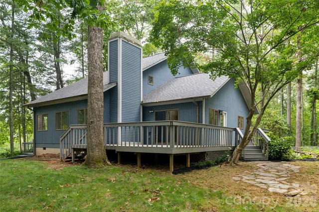 a view of a house with a yard and deck