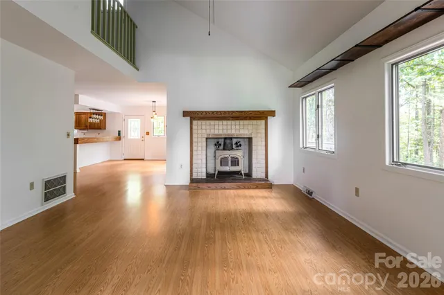 a view of a living room a window and wooden floor