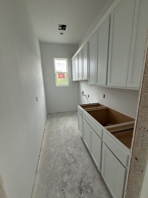 127 Riparian Elms Road Bertram, TX 78605 - Photo 8 of 22 Custom cabinetry and ample space define this functional laundry room, ready for your personalized touch.