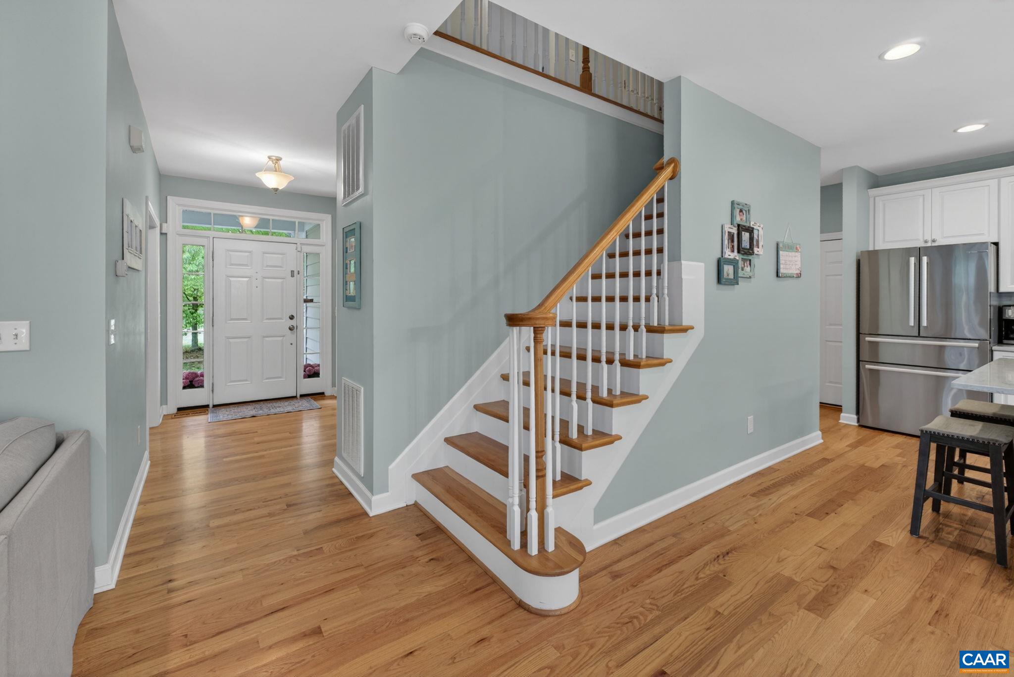 511 Taylor Ridge Way Palmyra, VA 22963 - Photo 11 of 57 a view of a hallway with wooden floor and staircase