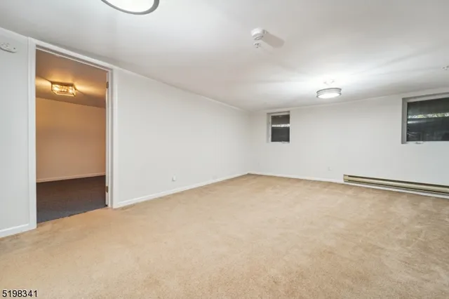 an empty room with a empty space and windows