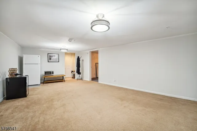 a view of a livingroom with furniture and a window