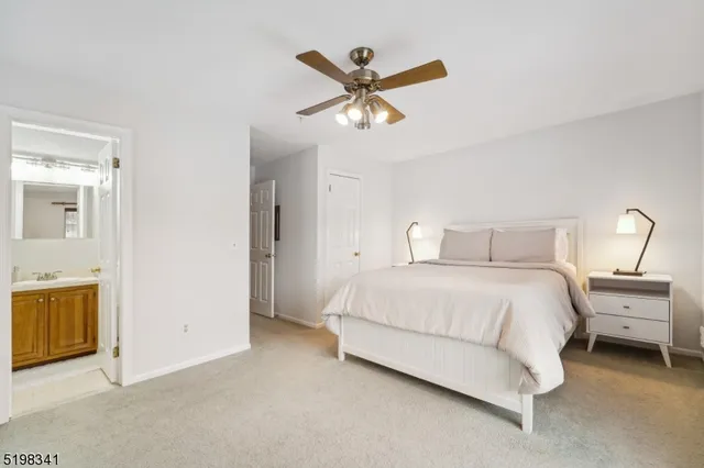 a bedroom with a bed and ceiling fan