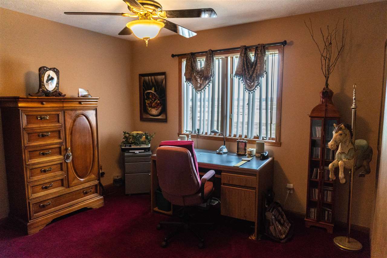 4545 River Road Cherry Valley, IL 61016 - Photo 11 of 25 a view of a workspace with furniture and a window