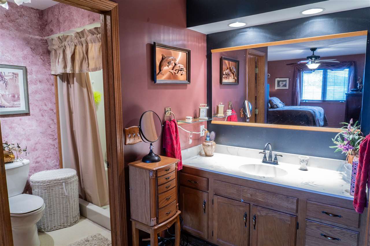 4545 River Road Cherry Valley, IL 61016 - Photo 12 of 25 a bathroom with a sink vanity mirror and toilet