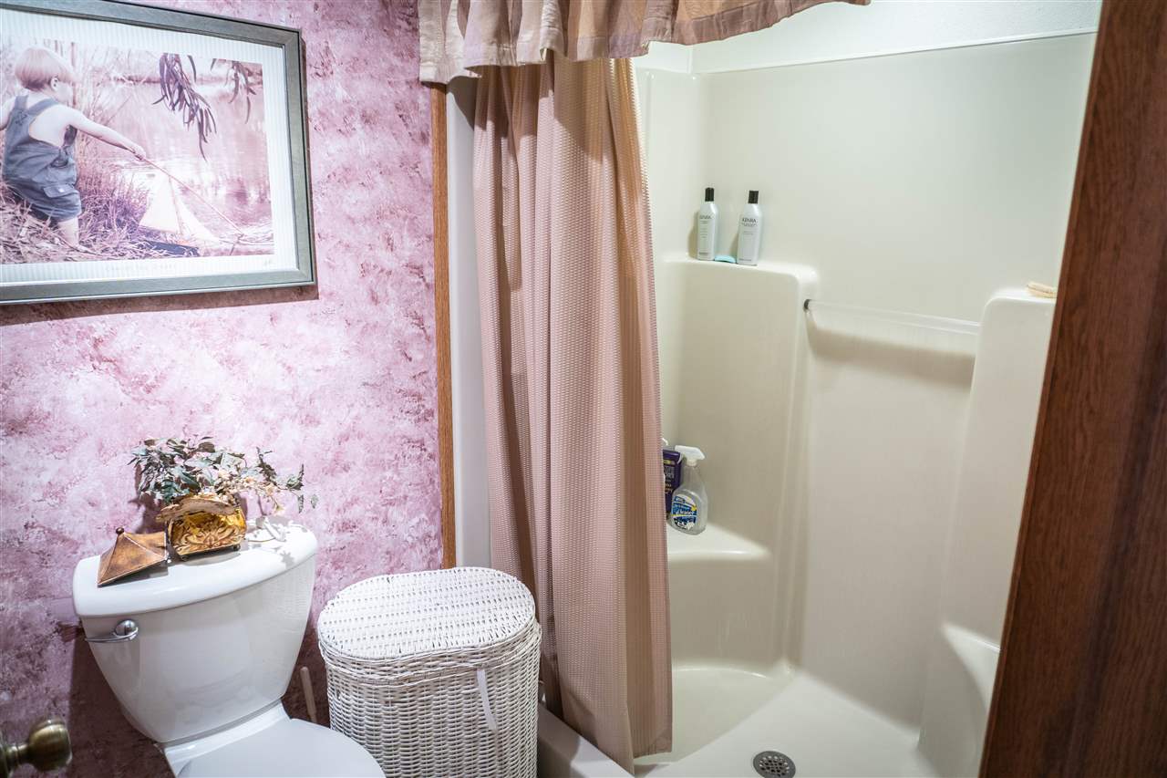 4545 River Road Cherry Valley, IL 61016 - Photo 13 of 25 a bathroom with a toilet and a shower curtain