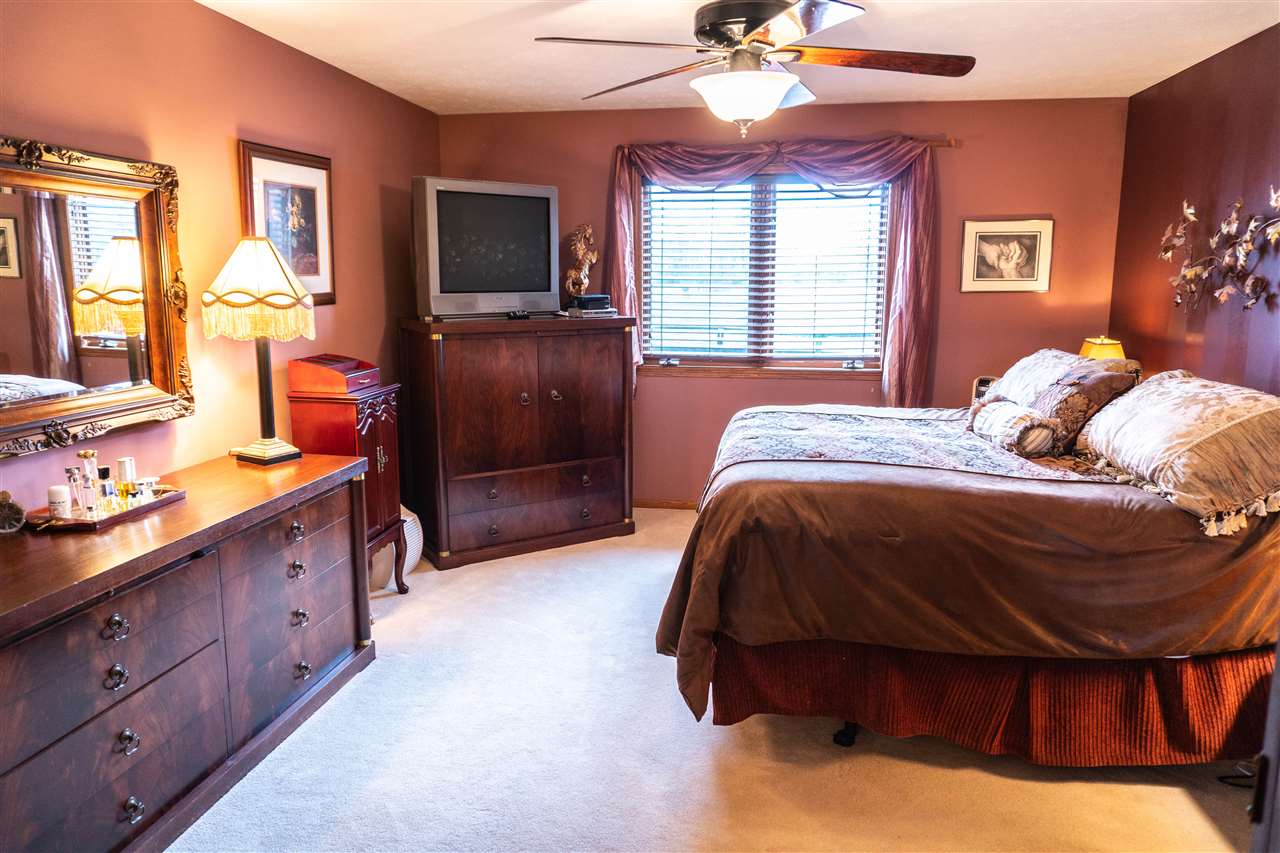 4545 River Road Cherry Valley, IL 61016 - Photo 14 of 25 a spacious bedroom with a bed and wooden floor