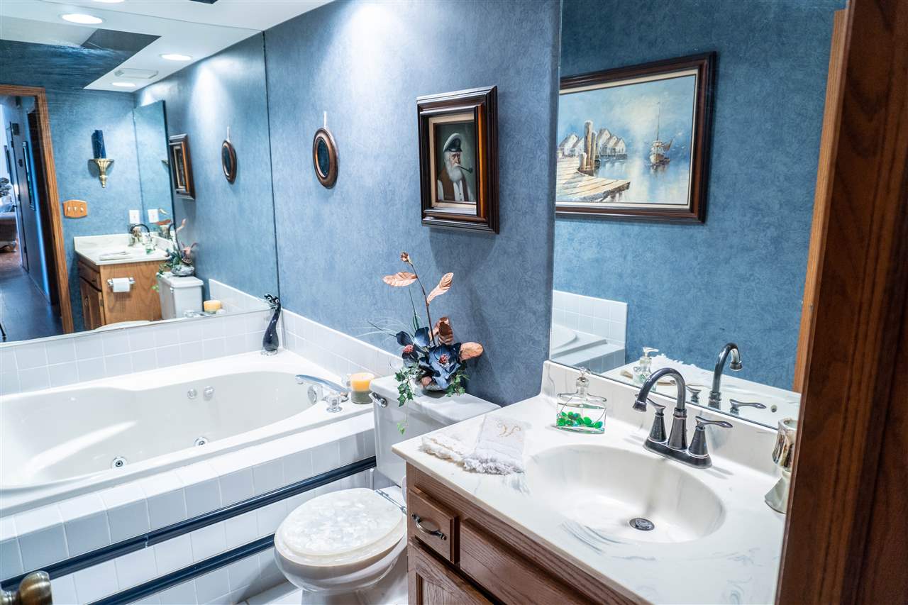 4545 River Road Cherry Valley, IL 61016 - Photo 16 of 25 a bathroom with a sink a toilet and a bathtub