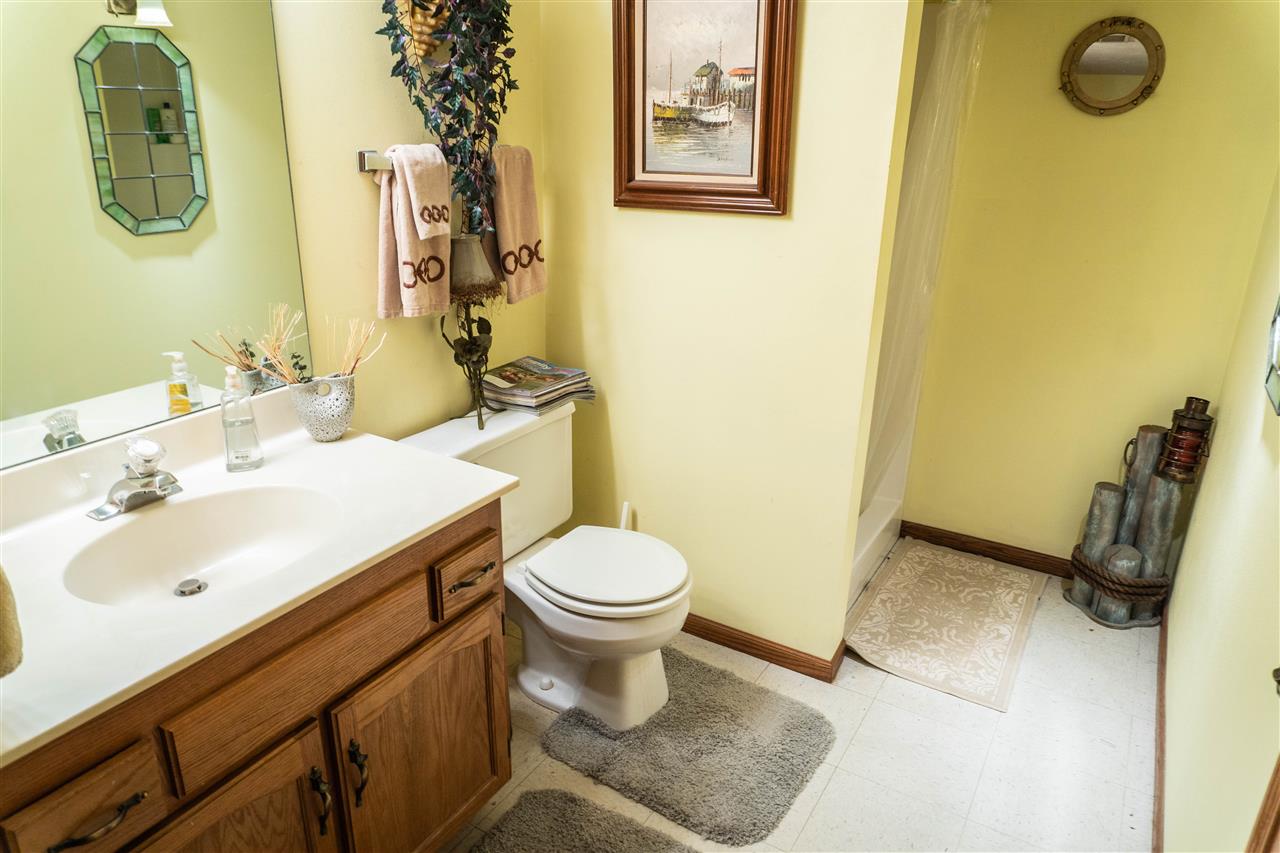4545 River Road Cherry Valley, IL 61016 - Photo 17 of 25 a bathroom with a sink and mirror with toilet