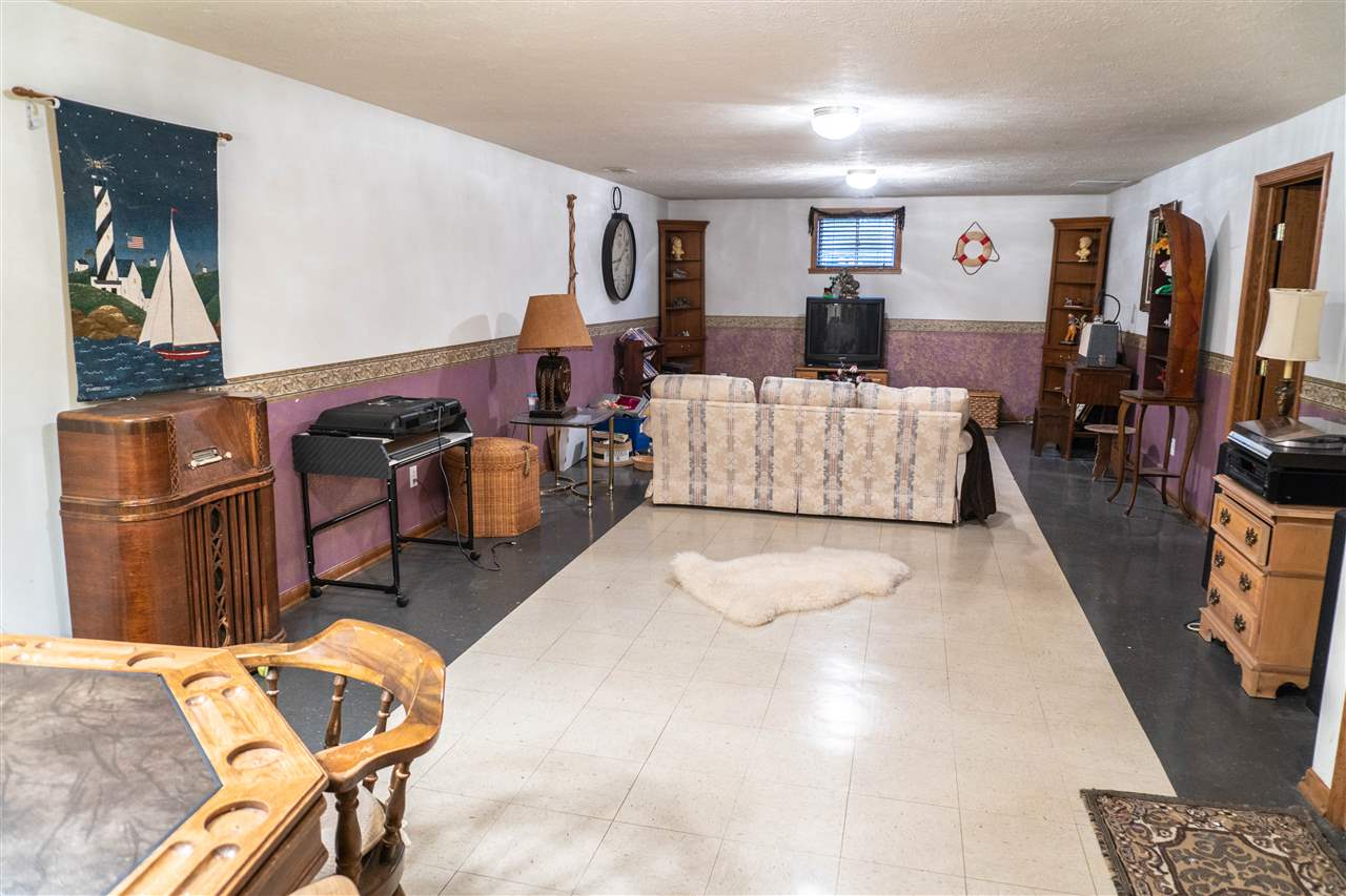 4545 River Road Cherry Valley, IL 61016 - Photo 18 of 25 a living room with furniture and a flat screen tv