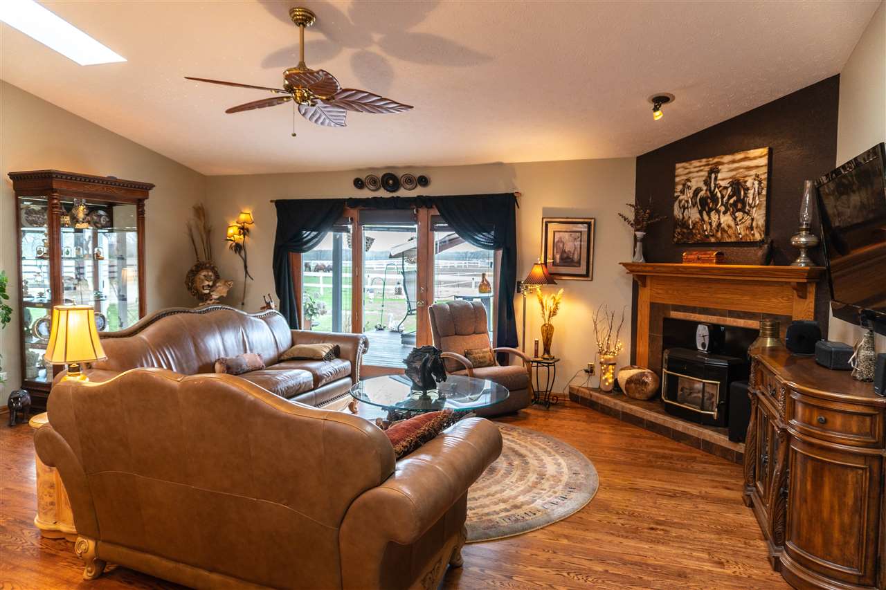 4545 River Road Cherry Valley, IL 61016 - Photo 4 of 25 a living room with fireplace furniture and a flat screen tv