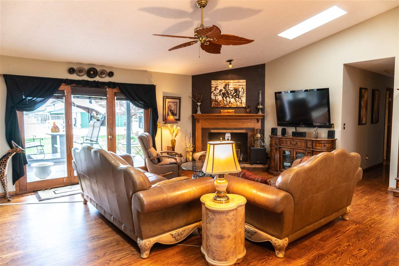 4545 River Road Cherry Valley, IL 61016 - Photo 5 of 25 a living room with furniture a flat screen tv and a large window