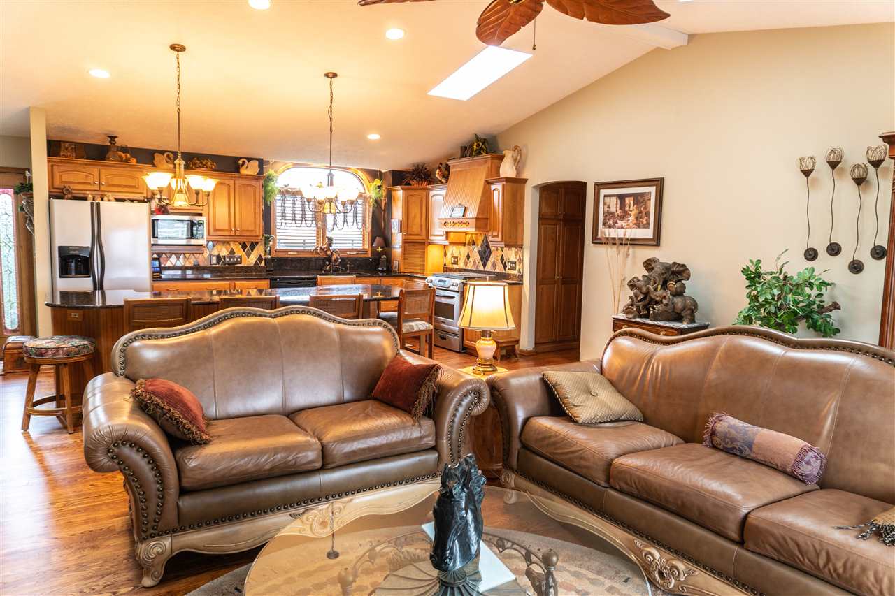 4545 River Road Cherry Valley, IL 61016 - Photo 10 of 25 a living room with furniture kitchen view and a chandelier