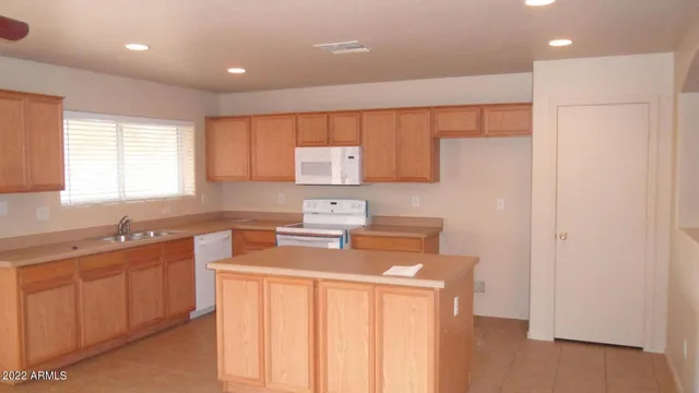 a kitchen with a sink a stove a refrigerator and cabinets