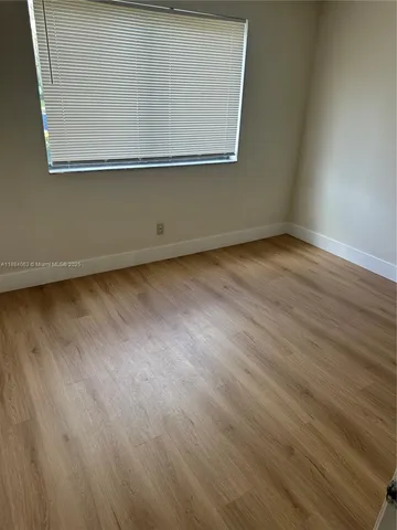 an empty room with wooden floor