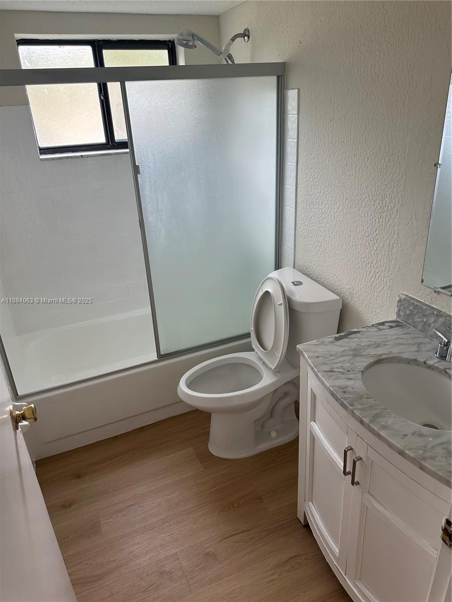 130 Northwest 60th Avenue, Unit 12 Margate, FL 33063 - Photo 12 of 16 a bathroom with a granite countertop sink toilet a mirror and shower