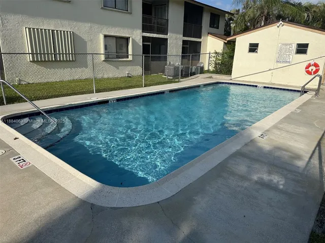 a view of a backyard with swimming pool