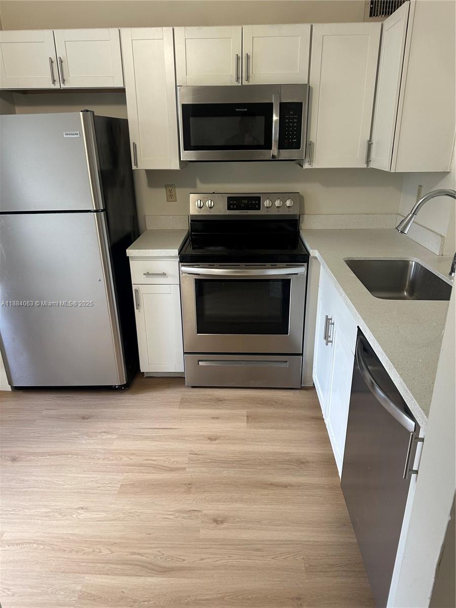 130 Northwest 60th Avenue, Unit 12 Margate, FL 33063 - Photo 3 of 16 a kitchen with appliances and cabinets