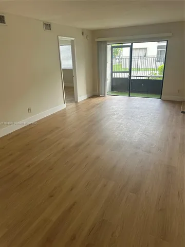 wooden floor and window in an empty room