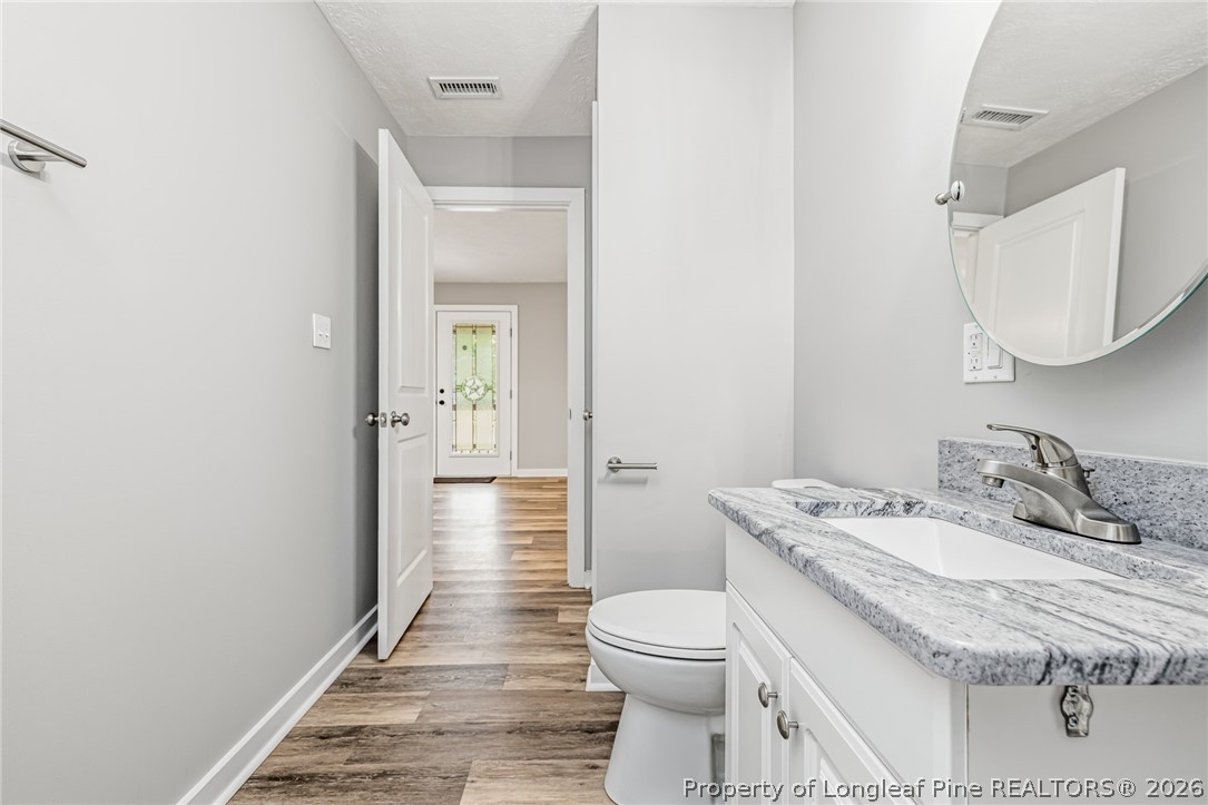 3524 Pine Log Road Lumberton, NC 28360 - Photo 23 of 42 a bathroom with a granite countertop sink a toilet and shower