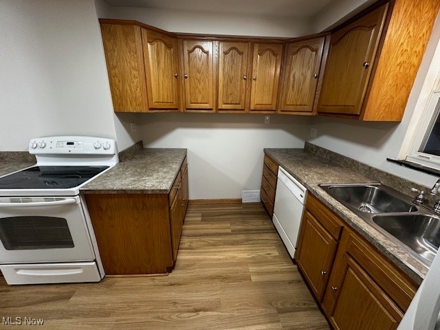 6606 Crossview Road Independence, OH 44131 - Photo 3 of 17 Kitchen featuring white appliances, brown cabinets, and dark countertops