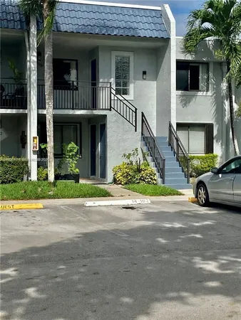 a view of a car park front of a house