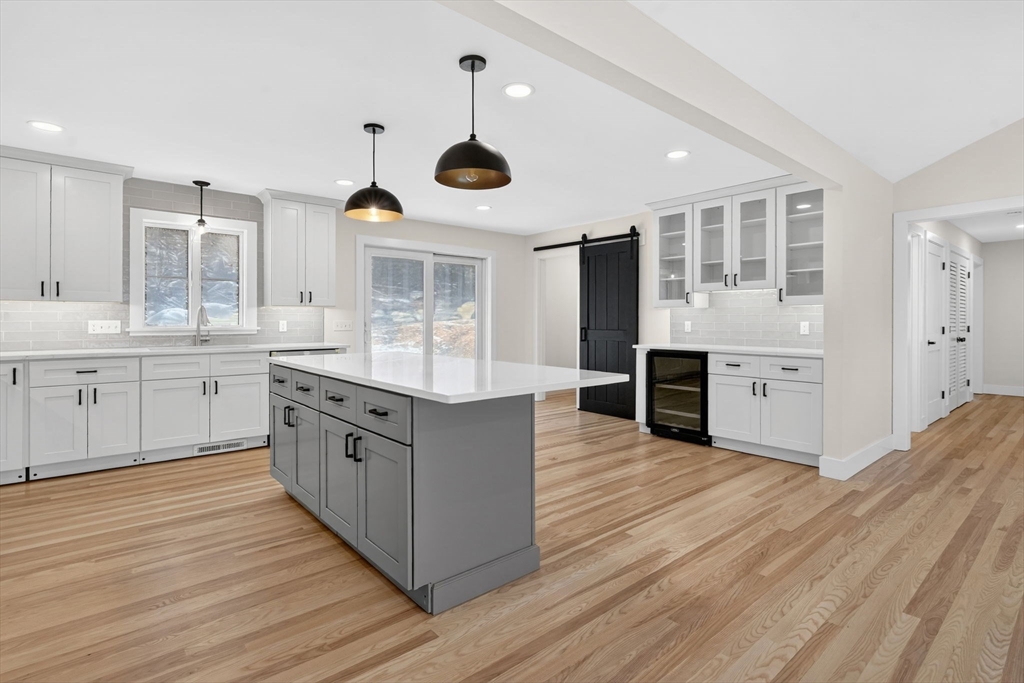 221 Cedar Swamp Road Monson, MA 01057 - Photo 12 of 37 a kitchen with stainless steel appliances granite countertop a white cabinets a sink dishwasher and a stove with wooden floor