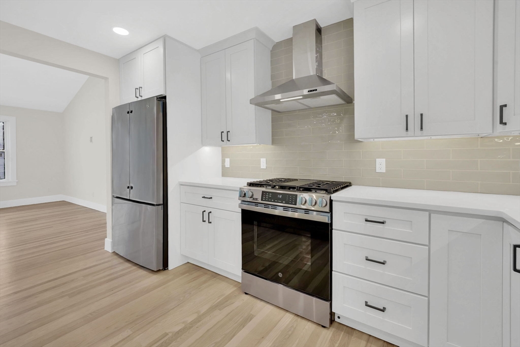 221 Cedar Swamp Road Monson, MA 01057 - Photo 15 of 37 a kitchen with stainless steel appliances a refrigerator stove and white cabinets