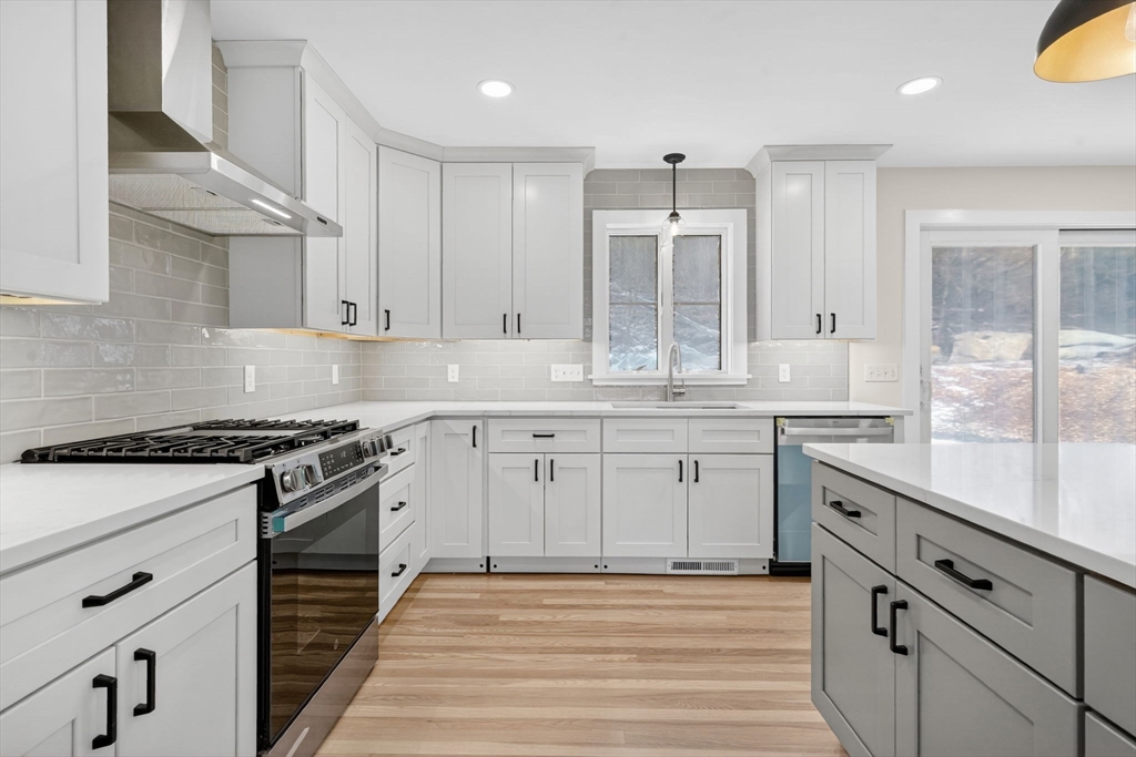 221 Cedar Swamp Road Monson, MA 01057 - Photo 17 of 37 a kitchen with stainless steel appliances granite countertop a stove a sink and a granite counter tops