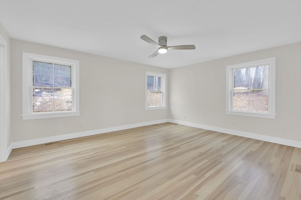 221 Cedar Swamp Road Monson, MA 01057 - Photo 23 of 37 a view of empty room with wooden floor and fan