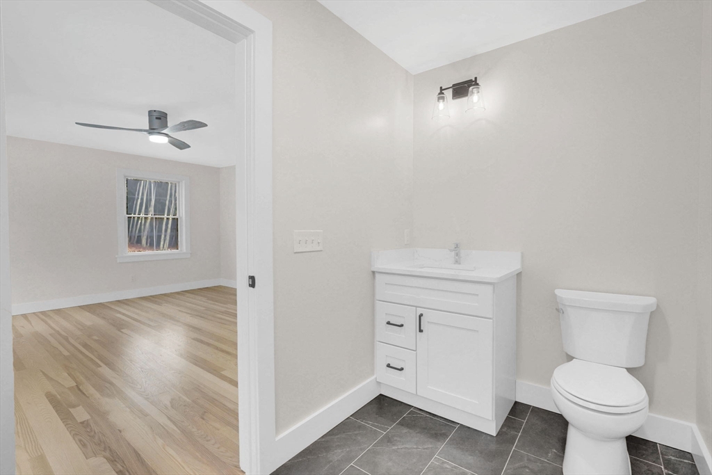 221 Cedar Swamp Road Monson, MA 01057 - Photo 26 of 37 a bathroom with a toilet sink and mirror