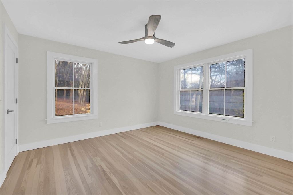 221 Cedar Swamp Road Monson, MA 01057 - Photo 27 of 37 a view of an empty room with wooden floor and a window