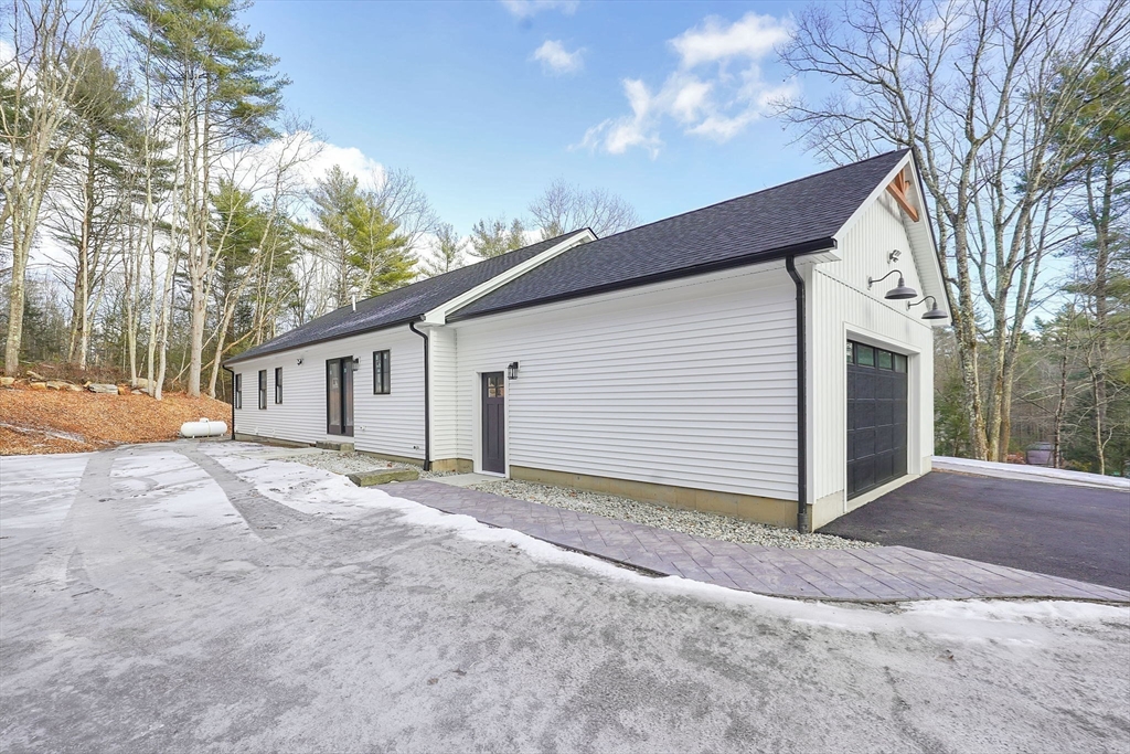 221 Cedar Swamp Road Monson, MA 01057 - Photo 32 of 37 a view of a house with a yard and garage