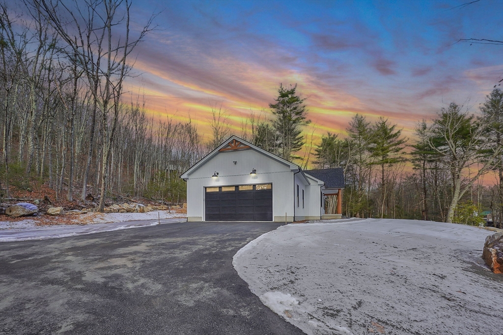 221 Cedar Swamp Road Monson, MA 01057 - Photo 7 of 37 a front view of a house with a yard and garage