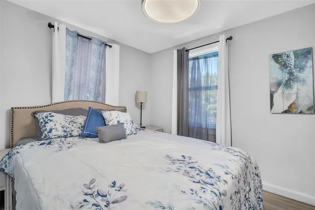 a bedroom with a large bed and a window