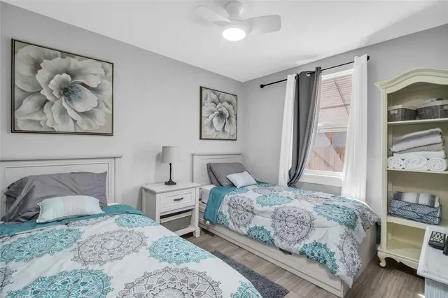 a bedroom with a bed and a painting on the wall