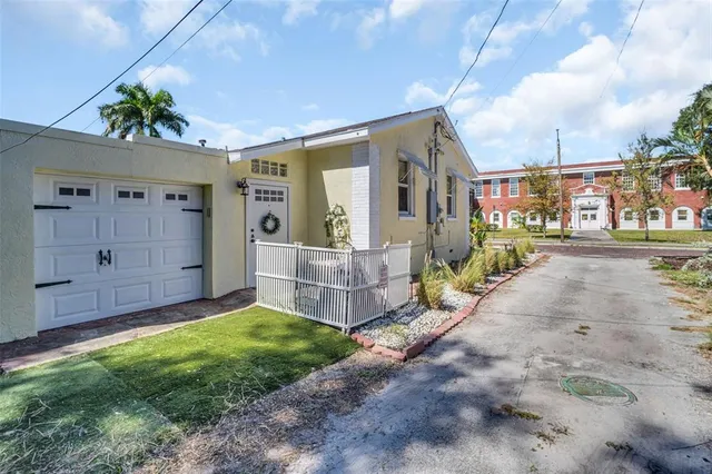 a view of a house with a yard and pathway