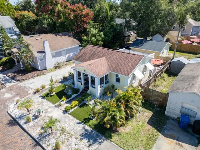 an aerial view of a house with a yard