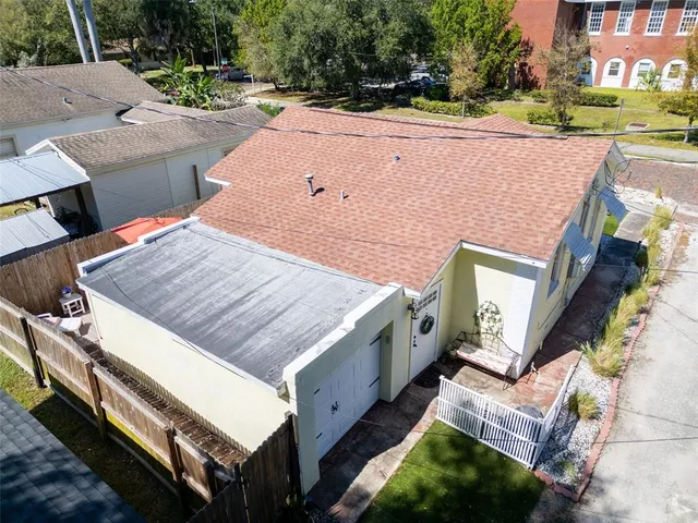an aerial view of a house with a yard