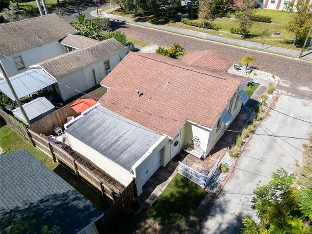 an aerial view of a house with a yard and potted plants