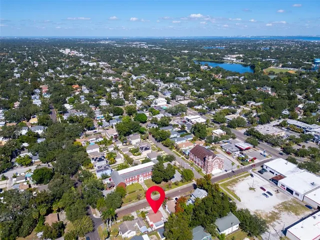 an aerial view of residential houses with city view