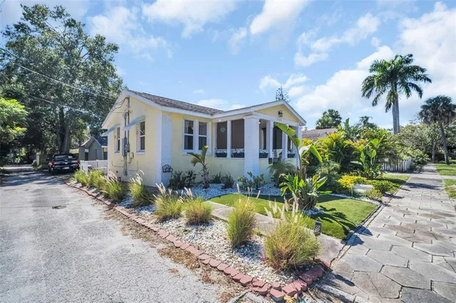 a view of a house with swimming pool and sitting area